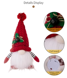 Detail view of gnome plush with red knit hat, small bell, full beard and battery compartment