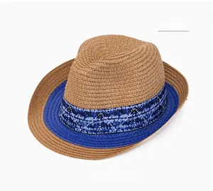 Detailed close-up of khaki woven sun hat featuring a blue tie-dye decorative ribbon band