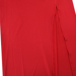 Detail view of high-slit red summer dress showing precise edge stitching and fabric texture