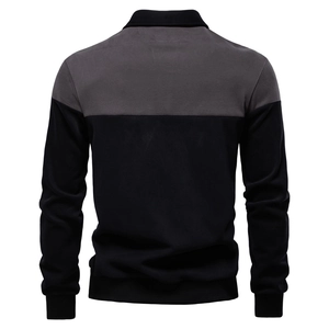 Detail view of the back of a long-sleeve polo sweatshirt with ribbed cuffs and two-tone color block
