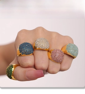 Detailed view of 18K gold plated PVD rings with multi-colored cubic zirconia stones