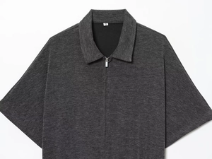 Detail of dark grey ribbed knit fabric with front metal zipper on short sleeve polo shirt