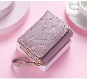 Detailed shot of women short wallet with cute embroidered hearts pink design compact wrist strap