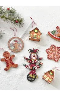 Macro shot of wooden Christmas ornaments featuring a glowing gingerbread house and snowflakes