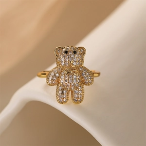 Macro view of gold-plated bear ring with pavé zircon stones and bow detail