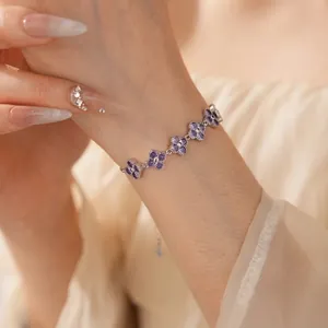 Exquisite silver clover bracelet with purple zircon stones on a model's wrist
