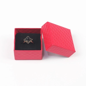 Detail of a black rose ring inside a red quilted pattern jewelry gift box display