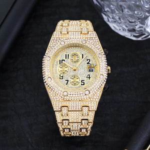 Detailed close-up of gold iced-out octagonal watch with diamonds on a black background