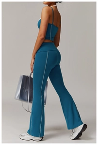 Détail du pantalon de yoga évasé bleu paon avec rayures latérales et haut court assorti