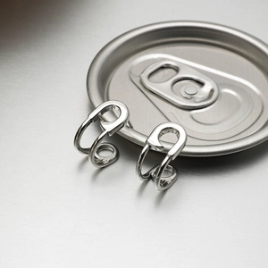 Detailed view of silver stainless steel pull-tab earrings in a modern industrial style