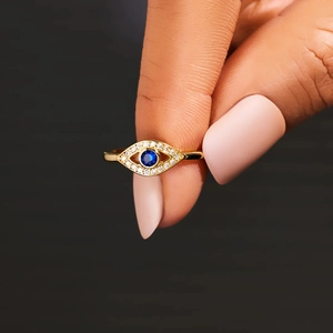 Detailed view of evil eye ring featuring blue center stone and white zircon pavé setting
