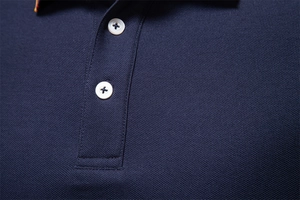 Macro shot of navy blue men's polo shirt showing piqué fabric and white buttons