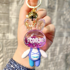 Detail of purple acrylic liquid quicksand rabbit keychain with gold bell and glitter