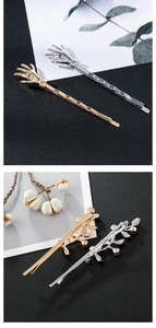 Detailed view of metal hand-shaped and branch-style hair clips in gold and silver finish