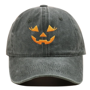 Close-up of orange Jack-o'-lantern embroidery on dark gray washed cotton baseball cap