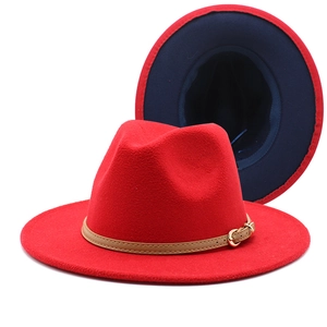 Detail view of red wool fedora hat with blue inner lining and khaki leather belt buckle