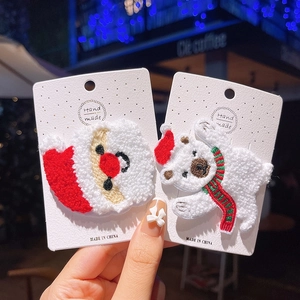 Detailed plush Christmas hair clips featuring Santa Claus and polar bear with embroidery
