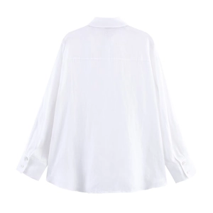 Detail view of the back seams and yoke on this white long-sleeve linen shirt