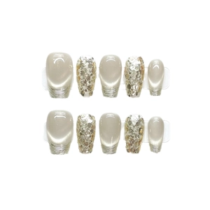 Press-on nails in cream cat eye effect and champagne gold sequins with glossy finish