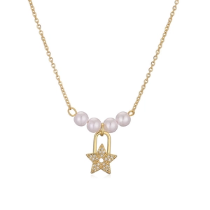 Elegant gold necklace featuring white pearls and a sparkling star pendant on white background