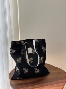 Detailed texture of jacquard fabric featuring retro rose patterns and a woven label