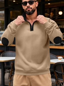 Detail of khaki pullover sweatshirt featuring black elbow patches and half-zip collar