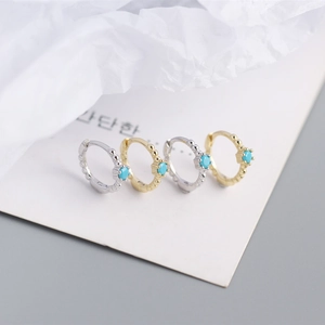Detailed macro view of S925 silver and gold ball edge hoop earrings with turquoise stones