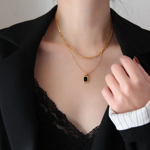 Close-up of double layer titanium steel necklace with a rectangular black gem pendant