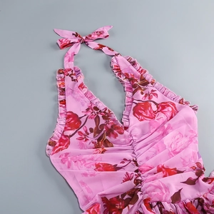 Flat lay of pink floral halter dress with bow neckline and ruffled collar detail