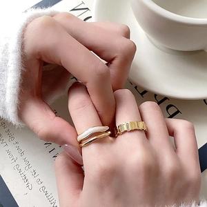 Minimalist gold wave pearl ring and chain zircon band set shown on a model hand