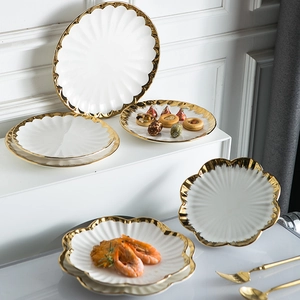 Nordic white ceramic plates set with elegant gold rims for dining and serving dessert