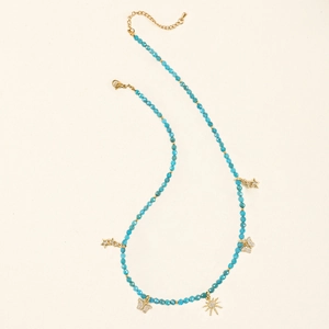 Detail of blue faceted beads necklace with gold butterfly pendants and lobster clasp