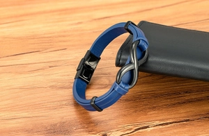 Macro shot of blue braided leather bracelet with black stainless steel infinity clasp