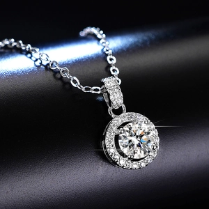 Macro shot of 1 carat moissanite halo necklace pendant with sparkling round cut stones
