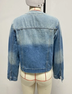 Detail view of the back of a slim-fit gradient wash denim jacket with multi-pocket design