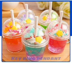 Detailed view of 5 mini ice cream cup keyrings in assorted pastel colors and starry decor