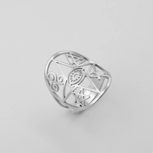 Detailed macro view of open ring featuring engraved eye, spiral, and Ankh cross motifs