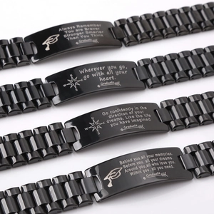 Macro shot of four black stainless steel link bracelets with graduation inspirational quotes