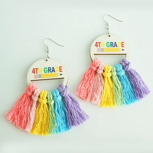 Detail view of 4th Grade wooden earrings featuring colorful pencil and hand-woven tassels
