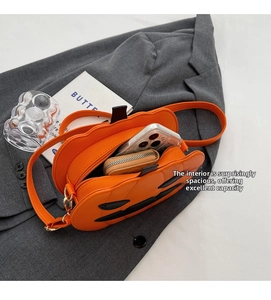 Internal view of Halloween pumpkin crossbody bag showing capacity for phone and wallet