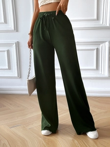Deep green wide leg trousers with elastic drawstring waistband and a loose fit for women