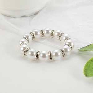 Elegant napkin ring with white faux pearls and rhinestone metal spacers on soft fabric
