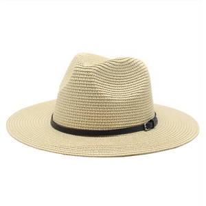 Detailed weave texture of summer straw fedora hat with black leather band and metal buckle