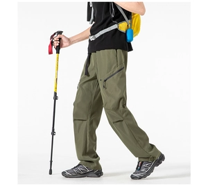 Detail of olive green cargo pants with zipper side pockets and built-in belt buckle