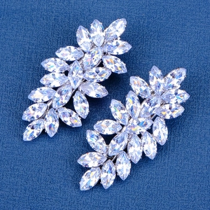 Elegant silver metal bow hairpin with marquise-cut crystals on dark blue background