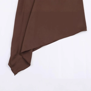 Women's dark brown satin halter top featuring an asymmetric hemline on white background