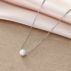 Minimalist silver box chain necklace featuring a glossy white pearl pendant on satin