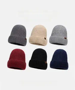 Selection of six warm winter beanies in various colors with stylish brown leather tags