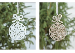Detail view of white and gold snowflake Christmas ornaments with glitter and silk ribbons