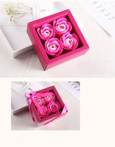 Detailed gift box with four realistic pink soap roses and a decorative silk ribbon bow